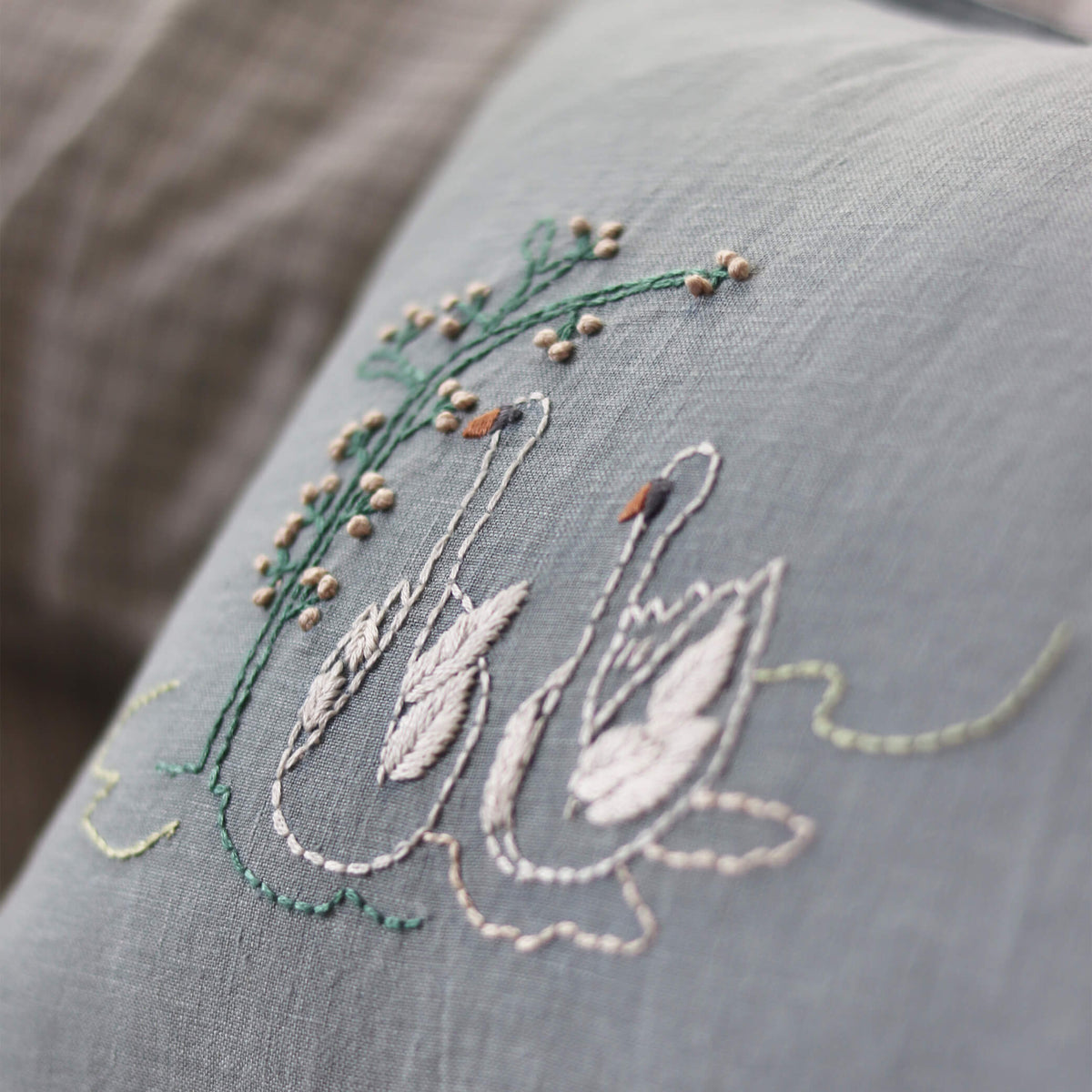 Camomile London swan embroidered cushion