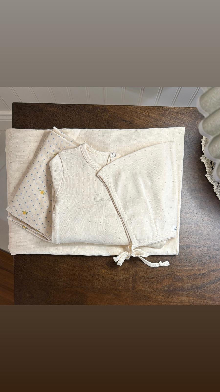 Lovely Littles Oatmilk Pointelle Blanket styled with matching babywear