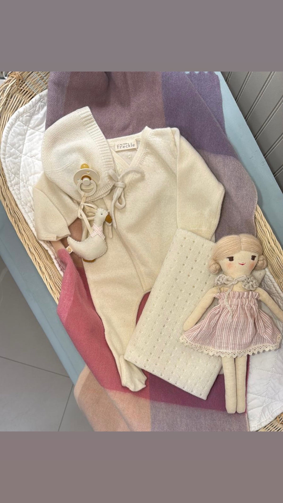 TBco Pink Block Check blanket styled with baby gifts